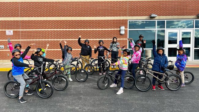 Children on Bikes Waving